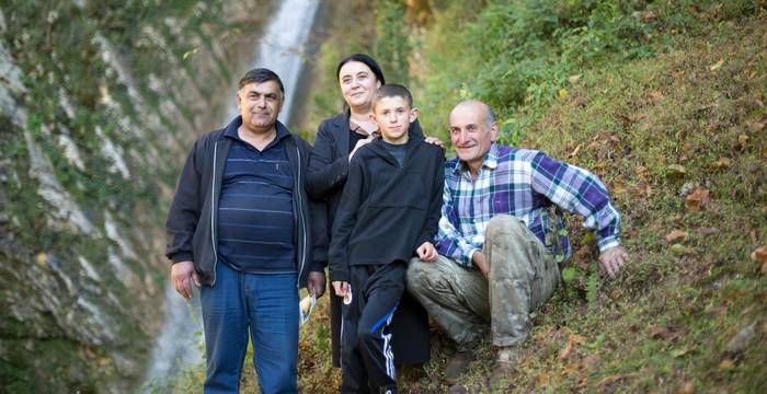 Die Projektkoordinatorin und weitere Teilnehmen vor einem Wasserfall in der Region Samegrelo, Georgien